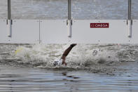 Ana Marcela Cunha, of Brazil, touches the timing board to win the women's marathon swimming competition at the 2020 Summer Olympics, Wednesday, Aug. 4, 2021, in Tokyo, Japan. (AP Photo/Jae C. Hong)