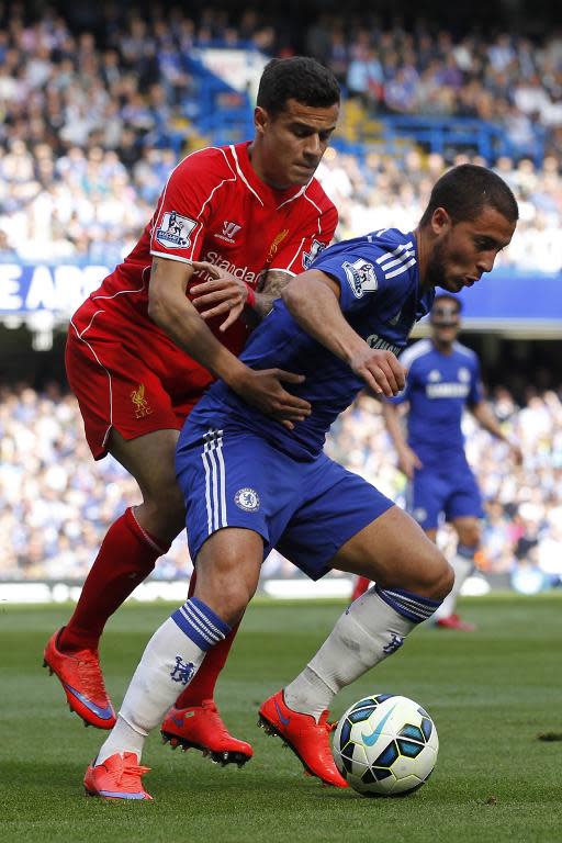 Liverpool's Philippe Coutinho (L) challenges Chelsea's Eden Hazard during their English Premier League match, at Stamford Bridge in London, on May 10, 2015