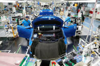 Employees of Toyota Motor Corp. work on the assembly line of Mirai fuel cell vehicle (FCV) at the company's Motomachi plant in Toyota, Aichi prefecture, Japan, May 17, 2018. Picture taken May 17, 2018. REUTERS/Issei Kato