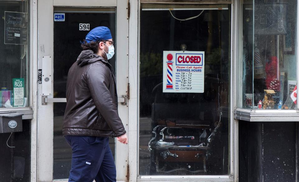 A man wearing a face mask walks past a closed hair salon in Toronto, Canada, on May 7, 2021. The Canadian unemployment rate rose 0.6 percentage point to 8.1 percent in April from March 2021 as public health measures against the COVID-19 pandemic were tightened, according to Statistics Canada on Friday. (Photo by Zou Zheng/Xinhua via Getty Images) (Xinhua/Zou Zheng via Getty Images)