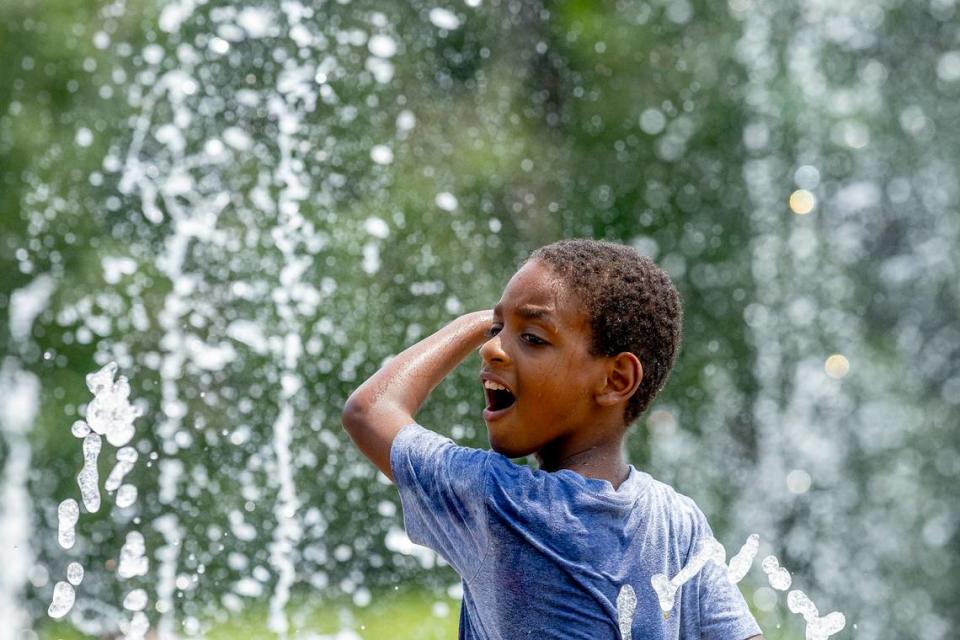 Jayden Smith, 7, of Lexington cools down at the Jacobson Park sprayground on Monday, June 17, 2024. With Tuesday temperatures forecasted to be 96 degrees, places like the sprayground are a good place for kids to cool down.