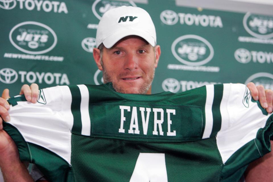 Brett Favre holds up his new New York Jets jersey at Cleveland Browns Stadium before an NFL exhibition football game between the New York Jets and Cleveland Browns Thursday, Aug. 7, 2008, in Cleveland. Favre was traded from the Green Bay Packers to the Jets earlier in the day. (AP Photo/Mark Duncan) ORG XMIT: OHMD101