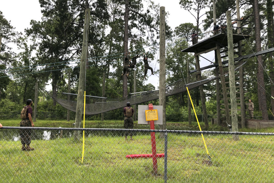 Female Marines go through one of the obstacles in the so-called confidence course designed to make them face their fears and gain confidence at Parris Island on May 27, 2020. In ways big and small, the virus is impacting training at the Marine Corps' Parris Island Recruit Depot and across the military. (AP Photo/Lolita Baldor)