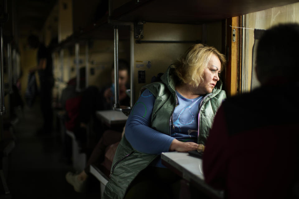 People fleeing from heavy shelling board an evacuation train at Pokrovsk train station, in Pokrovsk, eastern Ukraine, Sunday, May 22, 2022. Civilians fleeing areas near the eastern front in the war in Ukraine Sunday described scenes of devastation as their towns and villages came under sustained attack from Russian forces. (AP Photo/Francisco Seco)