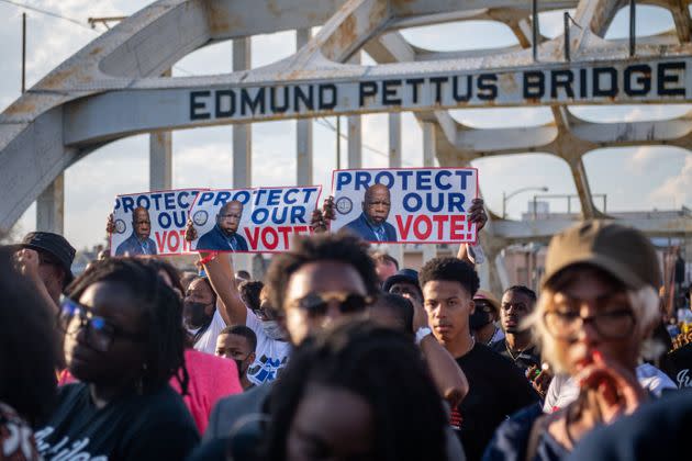 People march across the Edmund Pettus Bridge during commemorations for the 57th anniversary of 