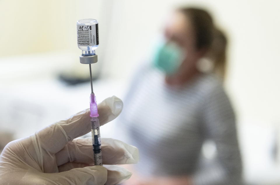 A nurse prepares a dose of Pfizer-BioNTech vaccine against the new coronavirus to be injected at the Andras Josa Teaching Hospital in Nyiregyhaza, Hungary, Sunday, Jan. 24, 2021. (Attila Balazs/MTI via AP)