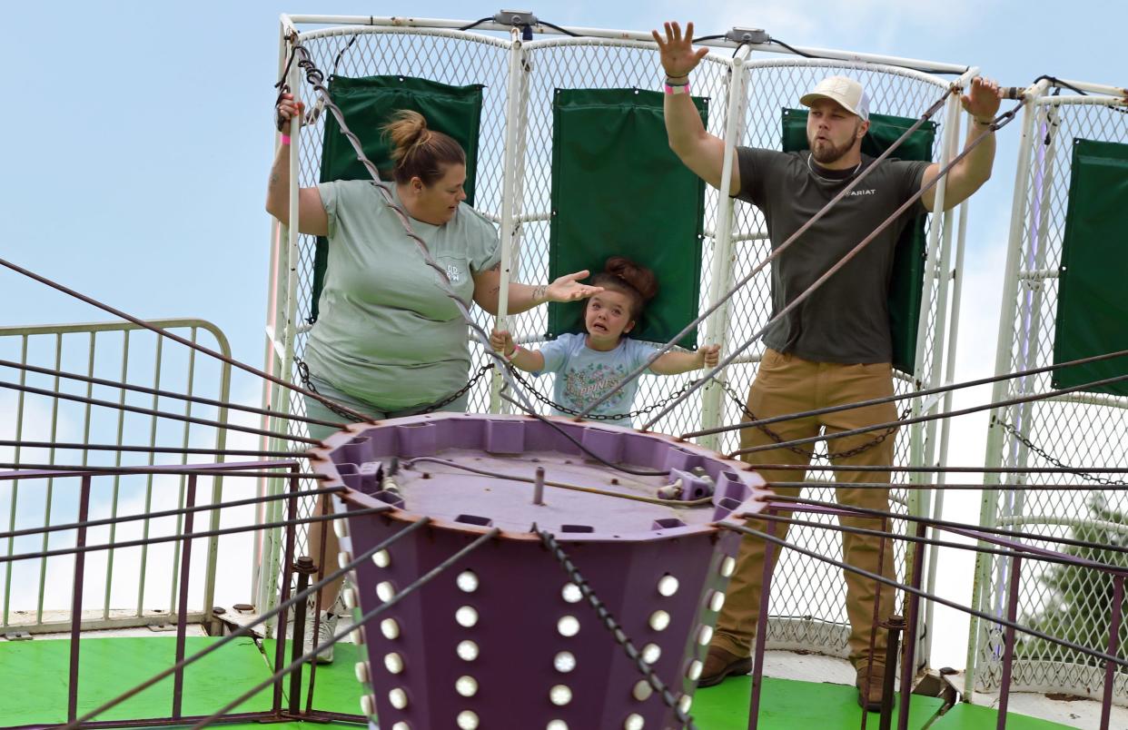 Ryan Rizzo raises his hands as Holly Cantrell tries to reassure her niece, six-year-old Destiny Hoffman, as they ride the Round Up during the 2024 Foothill's Merry-Go-Round Festival held Saturday, April 27, 2024, at the Shelby City Park.
