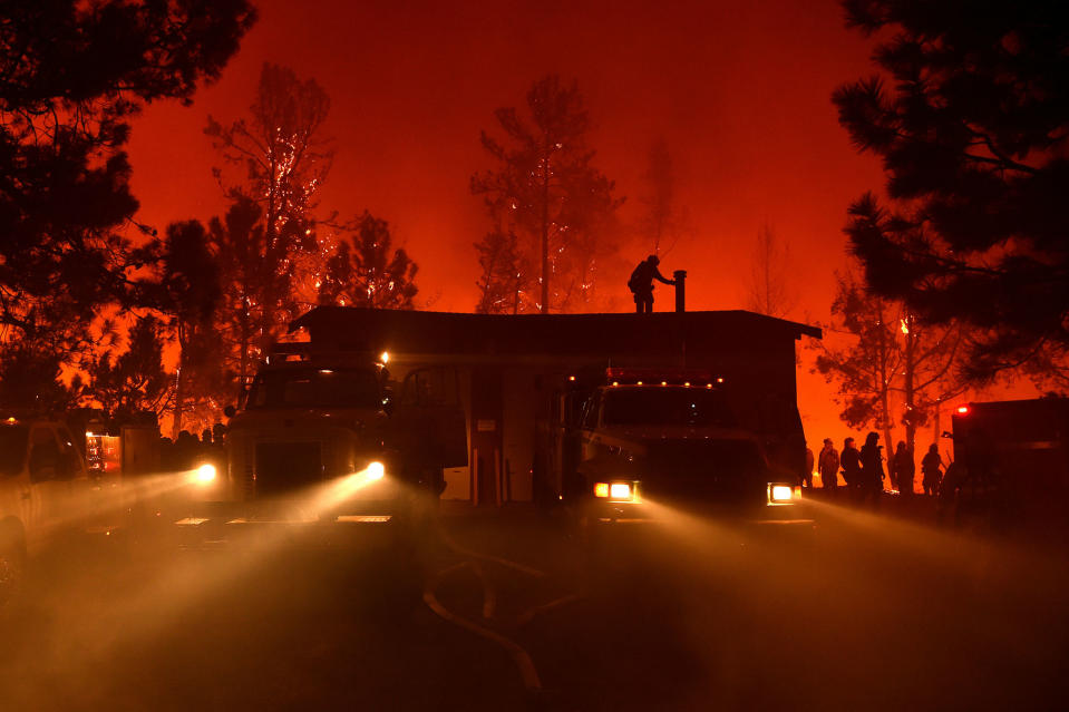 <p>Firefighters attempt to save the Casa Loma fire station in the Santa Cruz Mountains near Loma Prieta, California on September 27, 2016. The Loma Prieta Fire has charred more than 1,000 acres and burned multiple structures in the area. (Josh Edelson/AFP/Getty Images) </p>