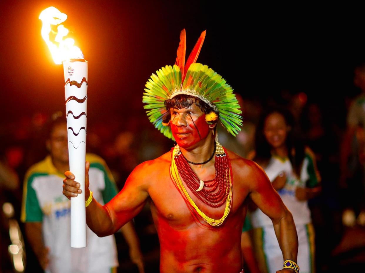 Raoni Vieira from Pataxo tribe takes part in the Olympic Flame torch relay in Porto Seguro, Bahia state, Brazil, May 19, 2016.