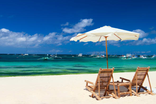 Beach chairs on perfect tropical white sand beach in Boracay, Philippines