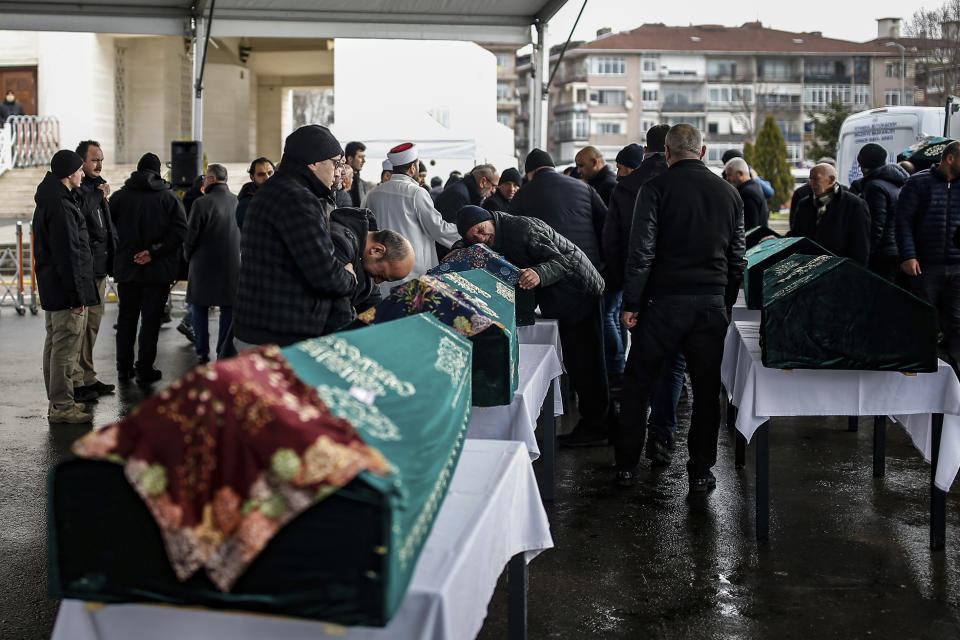 Mourners attend the funeral prayers for nine members of Alemdar family killed in a collapsed apartment building, in Istanbul, Saturday, Feb. 9, 2019. Turkey's President Recep Tayyip Erdogan says there are "many lessons to learn" from the collapse of a residential building in Istanbul where at least 17 people have died.(AP Photo/Emrah Gurel)