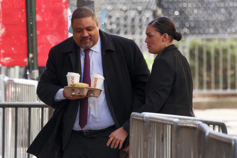 Manhattan district attorney Alvin Bragg, left, arrives at Manhattan criminal court, Tuesday, April 16, 2024, in New York. Donald Trump returns to a New York courtroom Tuesday as a judge works to find a panel of jurors who will decide whether the former president is guilty of criminal charges alleging he falsified business records to cover up a sex scandal during the 2016 campaign. (AP Photo/Yuki Iwamura)