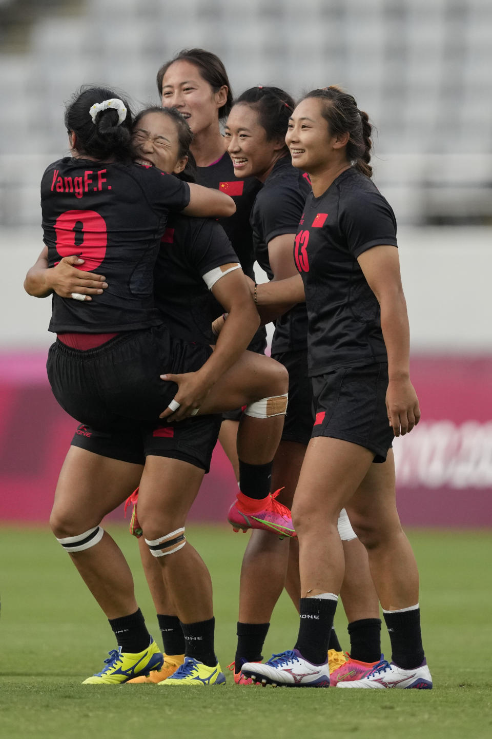 China players celebrate after defeating the Russian Olympic Committee team in their women's rugby sevens 7-8 placing match at the 2020 Summer Olympics, Saturday, July 31, 2021 in Tokyo, Japan. (AP Photo/Shuji Kajiyama)