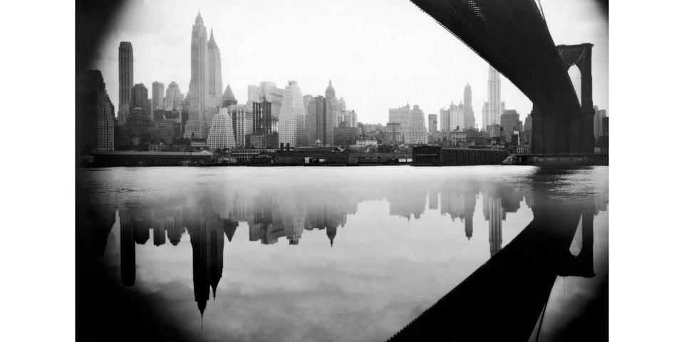 <p>A vantage point under the Brooklyn Bridge shows the reflection of the 1934 New York City skyline—which was a very different view from what's seen today.</p>