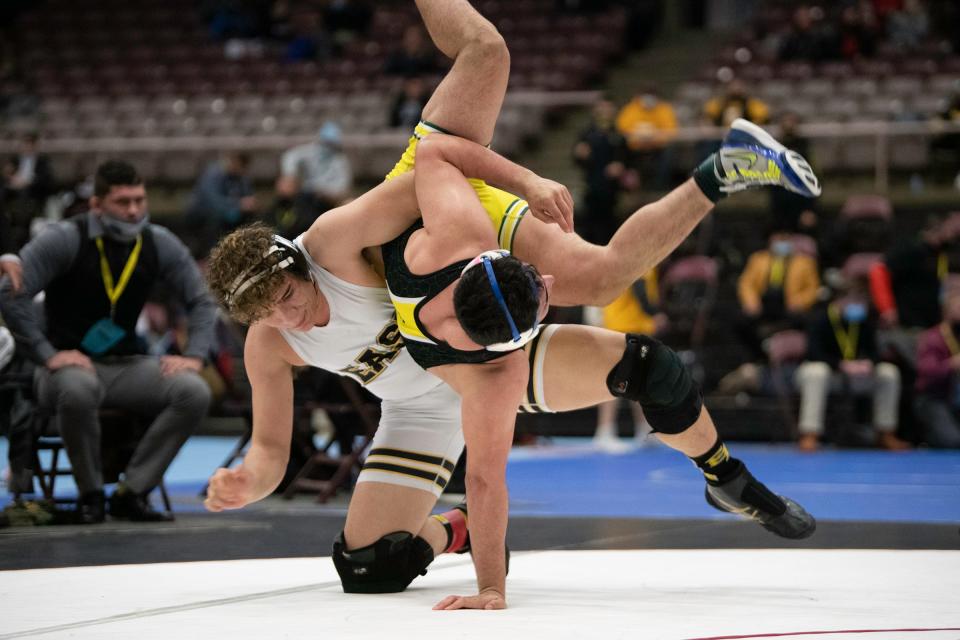 East High School’s Xavier Freeman dumps Pueblo County’s Bryce Garcia during the Class 4A 182-pound championship match at the Southwest Motors Events Center on Saturday March 13, 2021.