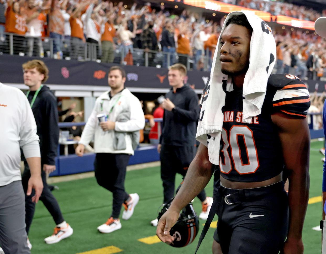 Oklahoma State's Collin Oliver (30) walks of the field following the Big 12 Football Championship game between the Oklahoma State University Cowboys and the Texas Longhorns at the AT&T Stadium in Arlington, Texas, Saturday, Dec. 2, 2023.