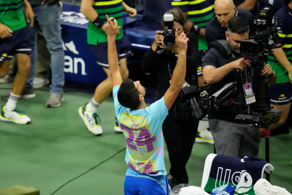 Novak Djokovic, of Serbia, reveals a t-shirt honoring the number 24 and Kobe Bryant after defeating Daniil Medvedev (AP)