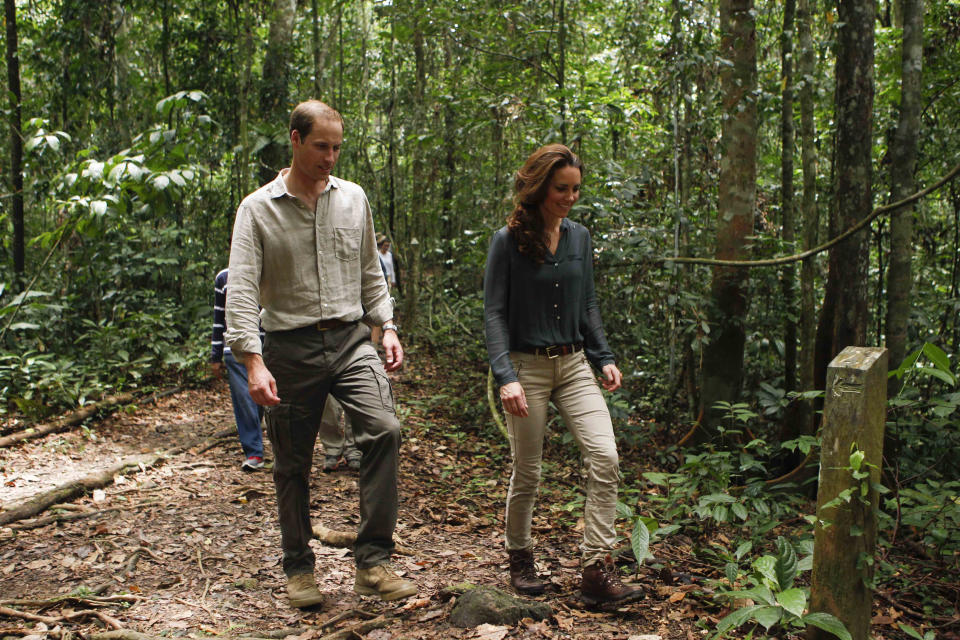 Prince William, left, and his wife Kate, the Duke and Duchess of Cambridge walk through the rainforest in Danum Valley Research Center in Danum Valley, Sabab, Malaysia, Saturday, Sept. 15, 2012. (AP Photo/ Vincent Thian, Pool)