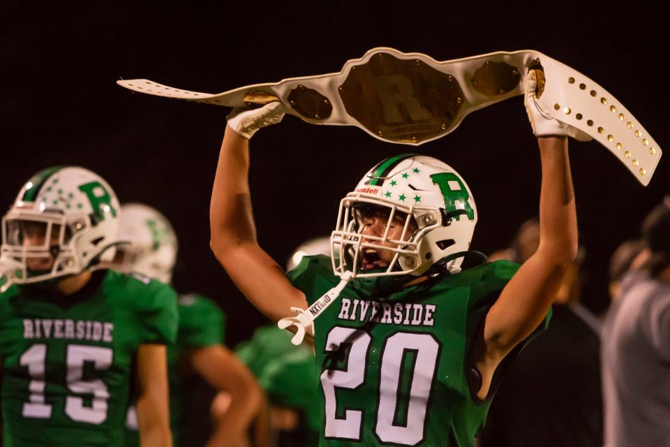 Riverside's  Brady Newman appears to be holding a championship belt as he celebrates yet another touchdown against Shenango during their game Friday at Riverside High School.  [Lucy Schaly/For BCT]