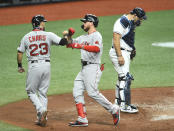 Tampa Bay Rays catcher Mike Zunino, right, looks down as Boston Red Sox's Michael Chavis (23) and Alex Verdugo, center, celebrate Verdugo's two-run home run off Rays starter Ryan Yarbrough during the fourth inning of a baseball game Wednesday, Aug. 5, 2020, in St. Petersburg, Fla. (AP Photo/Steve Nesius)