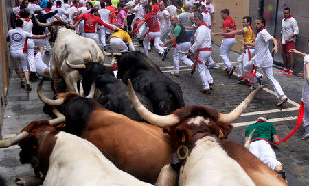 Runners sprint ahead of Fuente Ymbro fighting bulls during the fourth running of the bulls at the San Fermin festival in Pamplona, Spain July 10, 2017. REUTERS/Vincent West