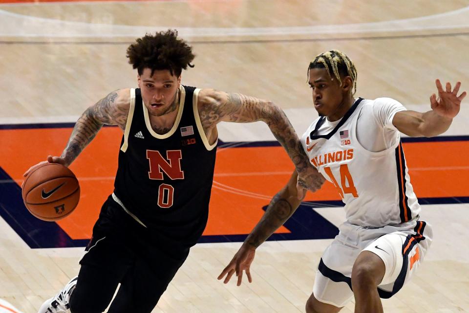 Nebraska's guard Teddy Allen (0) drives past Illinois guard Adam Miller (44) during the first half of an NCAA college basketball game Thursday, Feb. 25, 2021, in Champaign, Ill. (AP Photo/Holly Hart)