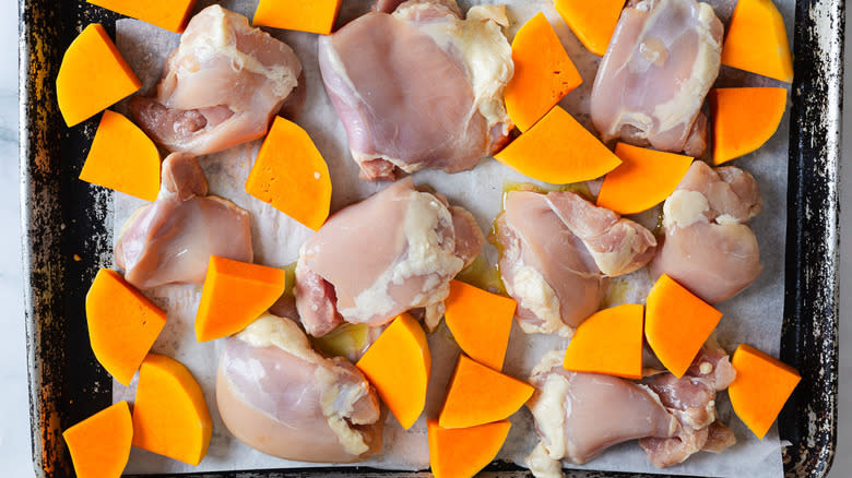 Chicken and squash on baking sheet