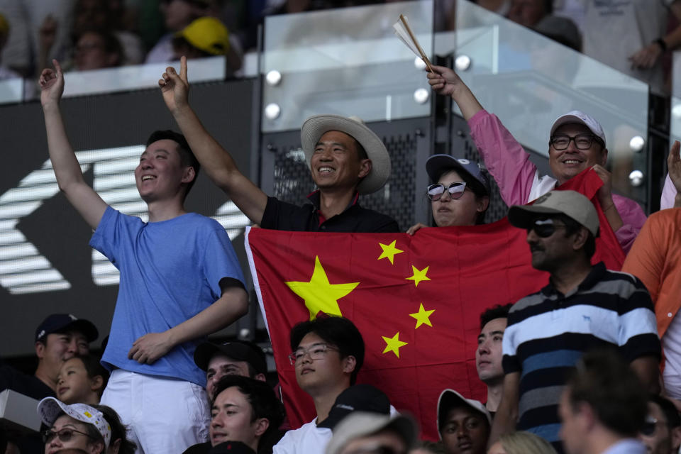 Supporters of Shang Juncheng of China react during his third round match against Carlos Alcaraz of Spain at the Australian Open tennis championships at Melbourne Park, Melbourne, Australia, Saturday, Jan. 20, 2024. (AP Photo/Andy Wong)