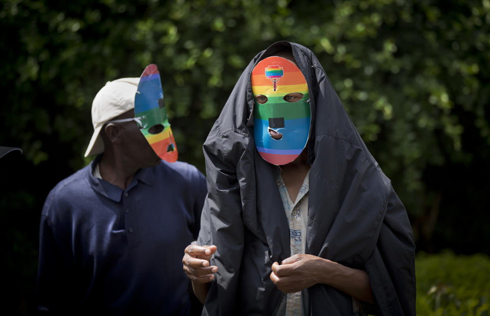 Kenyan gays and lesbians and others supporting their cause wear masks to preserve their anonymity as they stage a rare protest, against Uganda's increasingly tough stance against homosexuality and in solidarity with their counterparts there, outside the Uganda High Commission in Nairobi, Kenya Monday, Feb. 10, 2014. Homosexuality has been criminalized in Uganda where lawmakers have recently passed a new bill, which appears to have wide support among Ugandans, that prescribes life imprisonment for "aggravated" homosexual acts. (AP Photo/Ben Curtis)