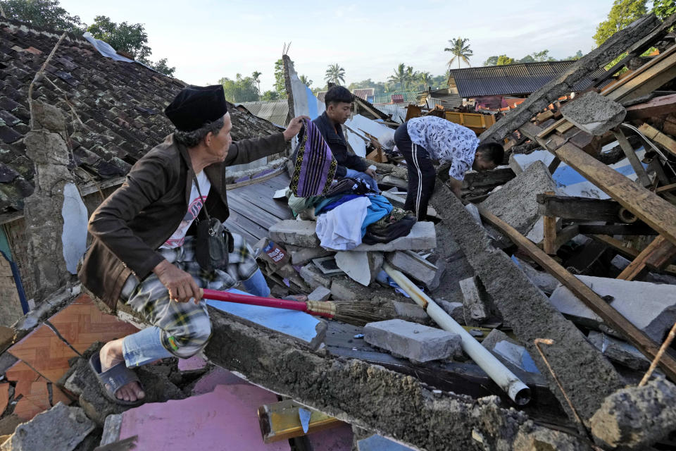 People look for usable items from their home destroyed in Monday's earthquake in Cianjur, West Java, Indonesia, Thursday, Nov. 24, 2022. The 5.6 magnitude earthquake left hundreds dead, injures and missing as buildings crumbled and terrified residents ran for their lives on Indonesia's main island of Java. (AP Photo/Tatan Syuflana)