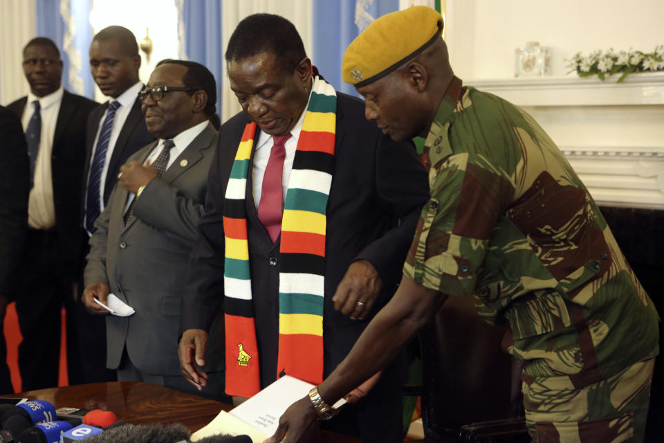 Zimbabwean President elect Emmerson Mnangagwa prepares to address a press conference in Harare ,Friday, Aug, 3, 2018. Zimbabwe's president says people are free to approach the courts if they have issues with the results of Monday's election, which he carried with just over 50 percent of the vote. President Emmerson Mnangagwa spoke to journalists shortly after opposition leader Nelson Chamisa called the election results manipulated and said they would be challenged in court. (AP Photo/Tsvangirayi Mukwazhi)