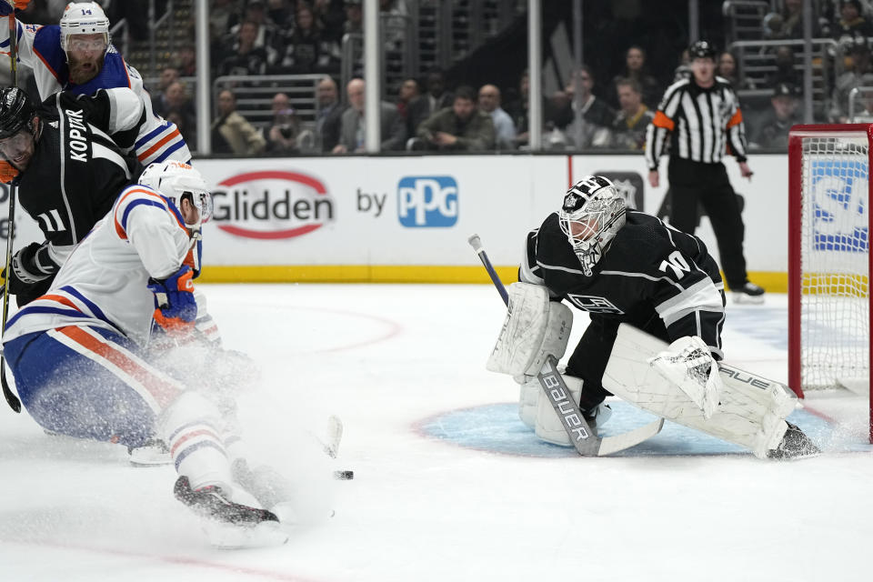 Edmonton Oilers center Connor McDavid, left, attempts to score on Los Angeles Kings goaltender Joonas Korpisalo during the first period in Game 3 of an NHL hockey Stanley Cup first-round playoff series Friday, April 21, 2023, in Los Angeles. (AP Photo/Mark J. Terrill)