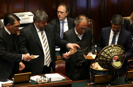 Assistants count ballot papers at the end of the voting session at the Chambers of Deputies during the first session since the March 4 national election in Rome, Italy March 23, 2018. REUTERS/Tony Gentile