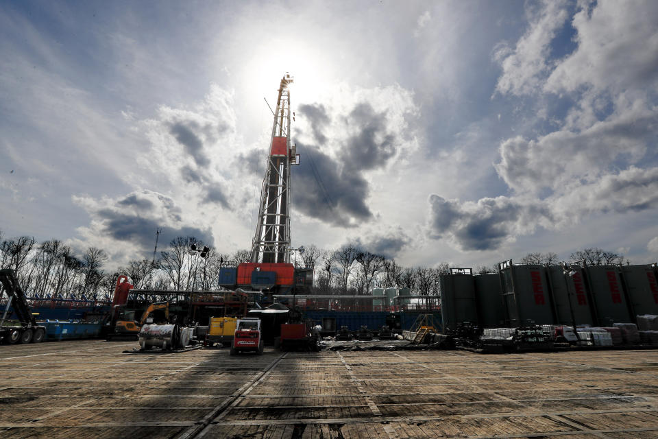 FILE - In this March 12, 2020, file photo, the sun shines through clouds above a shale gas drilling site in St. Mary's, Pa. President Donald Trump's administration is expected to undo Obama-era rules designed to limit greenhouse gas emissions from oil and gas fields and pipelines, formalizing the changes in the heart of the nation's most prolific natural gas reservoir and in the premier presidential battleground state of Pennsylvania. (AP Photo/Keith Srakocic, File)