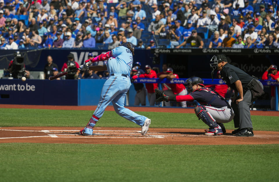 Toronto Blue Jays first baseman Vladimir Guerrero Jr. (27) hits a single against the Washington Nationals during the first inning of a baseball game in Toronto on Wednesday, Aug. 30, 2023. (Andrew Lahodynskyj/The Canadian Press via AP)