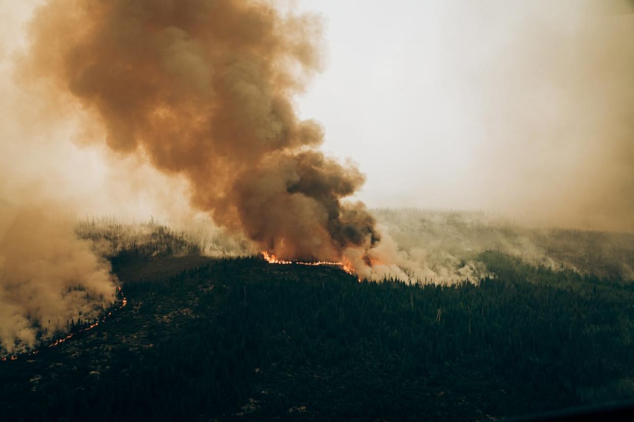 A wildfire raging west of Chibougamau, in northern Quebec, is shown on June 4. A new study suggests the record-setting season in Quebec this year was made more likely by climate change. (Audrey Marcoux/The Canadian Press - image credit)