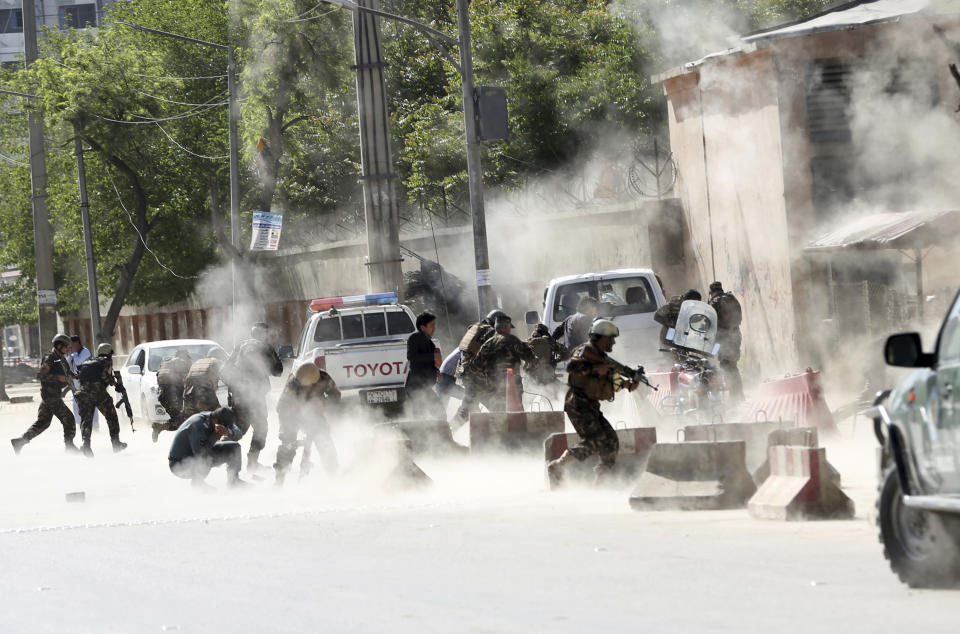 <p>Security forces run from the site of a suicide attack after the second bombing in Kabul, Afghanistan, April 30, 2018. (Photo: Massoud Hossaini/AP) </p>