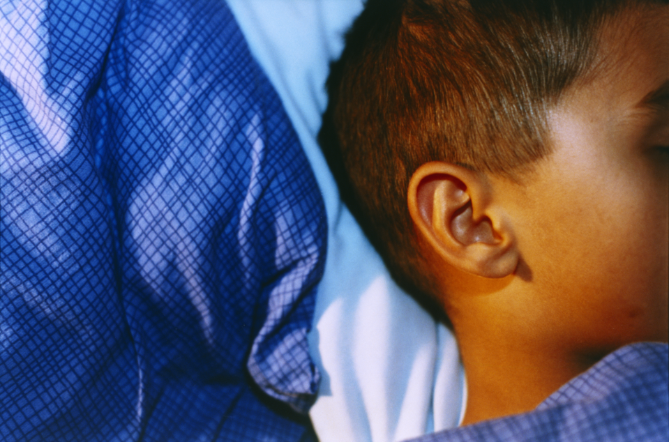 The head of a child asleep, against a pillow