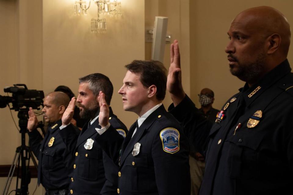 Sgt Aquilino Gonell of the US Capitol police, Michael Fanone of the Metropolitan police, Daniel Hodges of the Metropolitan police and Harry Dunn of the US Capitol Police are sworn in.