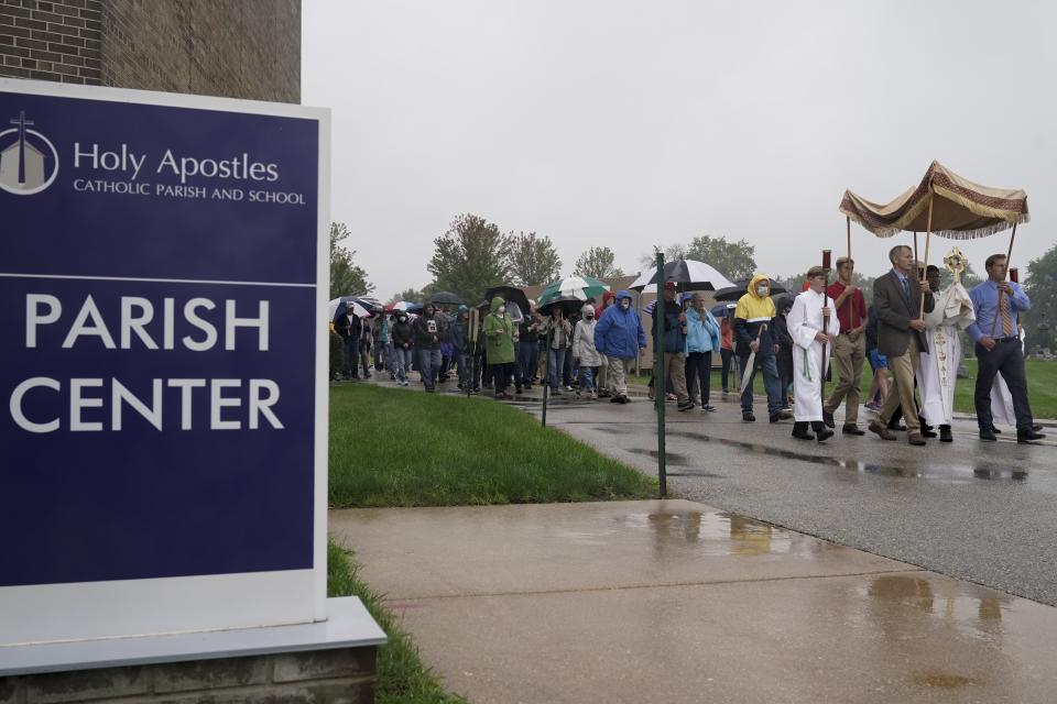 Churchgoers participate in a procession at the Holy Apostles Church in Milwaukee, Saturday, Sept. 12, 2020. For decades, Roman Catholic voters have been a pivotal swing vote in U.S. presidential elections, with a majority backing the winner — whether Republican or Democrat — nearly every time. (AP Photo/Morry Gash)