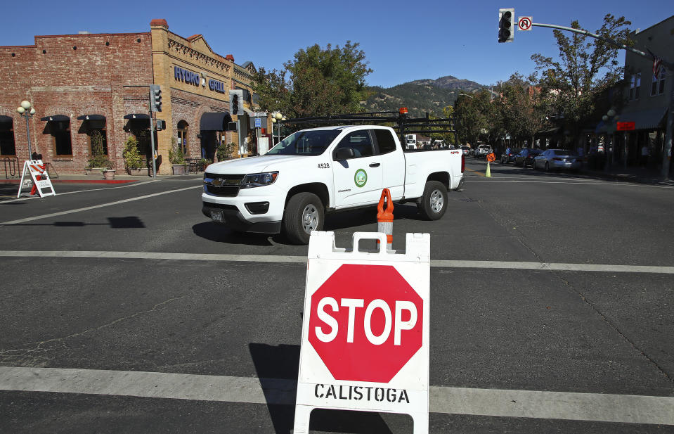 A city of Calistoga, Calif., truck makes a turn in an intersection without traffic light signals Monday, Oct. 15, 2018, in Calistoga. Northern California's biggest utility has taken the unprecedented step of cutting electricity for tens of thousands of customers in an attempt to prevent wildfires amid rising winds and official warnings on Monday of extreme fire danger. (AP Photo/Ben Margot)