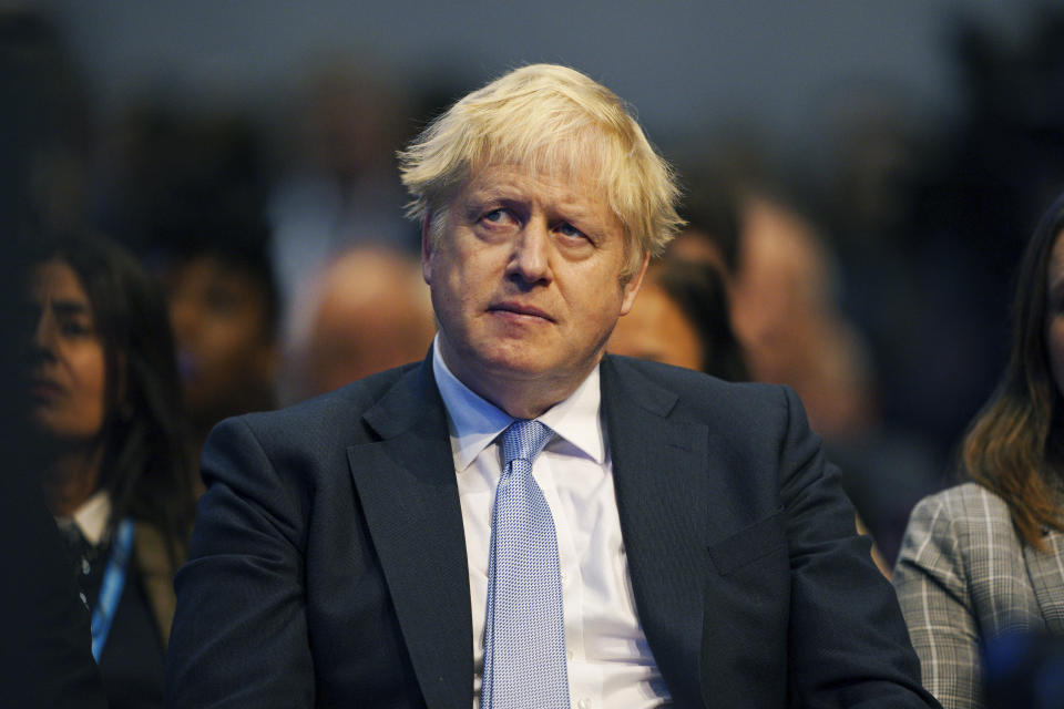 Britain's Prime Minister Boris Johnson watches as Chancellor of the Exchequer Rishi Sunak speaks during the Conservative Party Conference in Manchester, England, Monday, Oct. 4, 2021. (Peter Byrne/PA via AP)