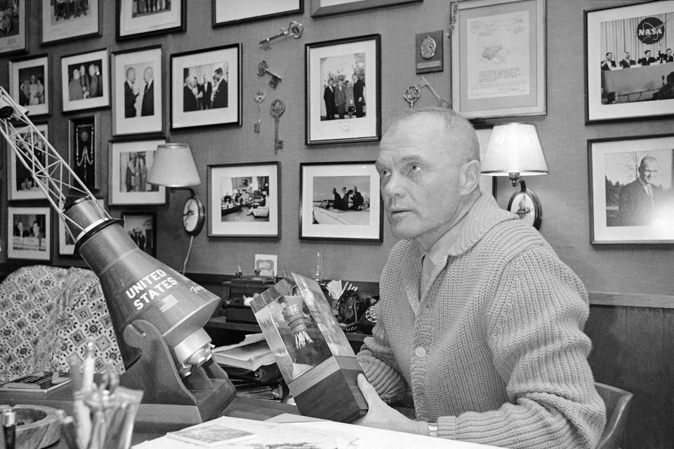 In this Feb. 13, 1967, file photo, astronaut John Glenn sits among mementos of his career at his home in Houston. Fans of the late astronaut are working to bring a statue of his likeness to the Ohio Statehouse to mark major future milestones, such as his birthday and the anniversary of his famous space flight. Thursday marks 58 years since Glenn became the first American to orbit the Earth, making him an instant national hero in 1962.(AP Photo)