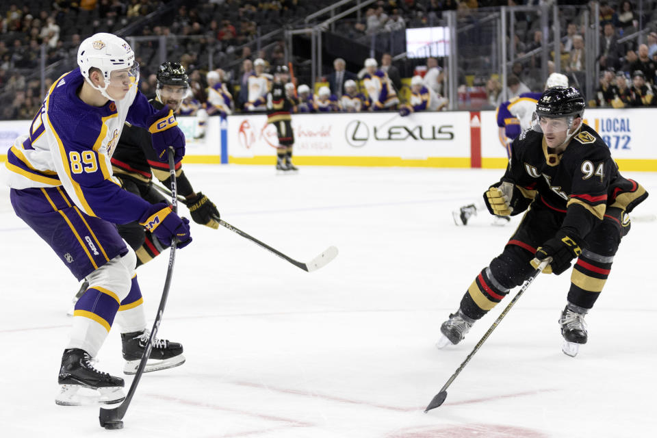 Los Angeles Kings center Rasmus Kupari (89) shoots as Vegas Golden Knights defenseman Brayden Pachal (94) defends during the third period of an NHL hockey game Saturday, Jan. 7, 2023, in Las Vegas. (AP Photo/Ellen Schmidt)