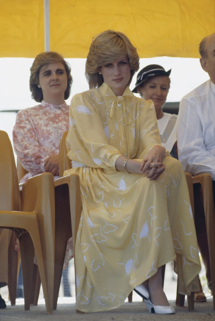 Princess Diana chose a sunny pussy-bow dress by Jan van Velden to kickstart the Royal Tour of Australia at Alice Springs Airport in 1983. <em>[Photo: Getty]</em>