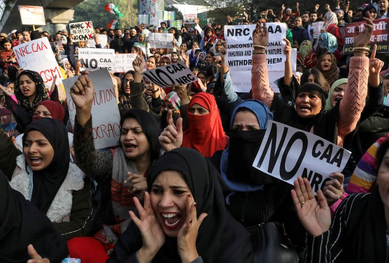 Demonstrators carry posters during a protest against a new citizenship law, outside the Jamia Millia Islamia University in New Delhi