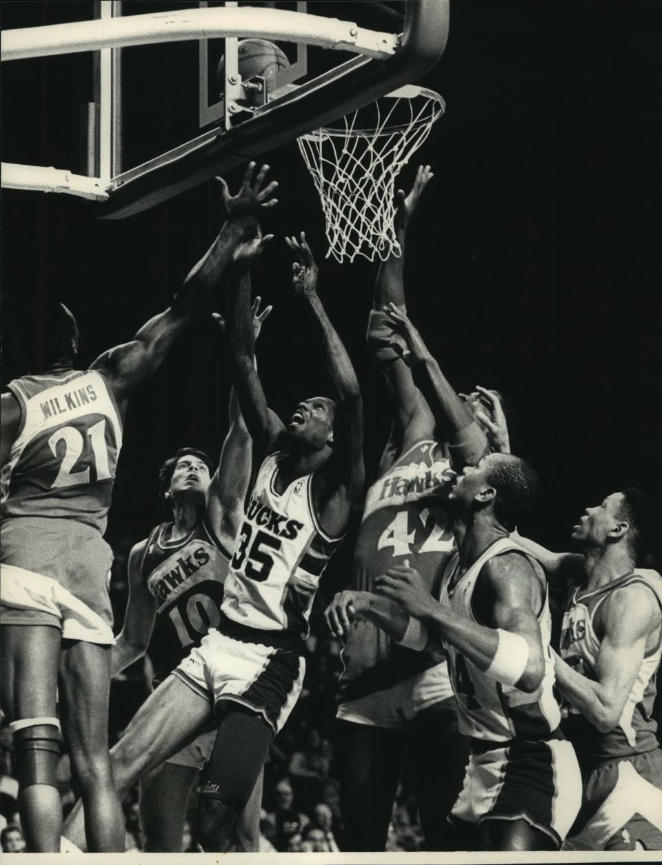 The Bucks' Jerry Reynolds (35) put up a shot in traffic against Atlanta in the 1988 playoffs, surrounded by Hawks defenders Dominique Wilkins (21), Randy Wittman (10)  and Kevin Willis (42).