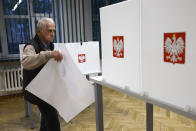 Man prepares to cast his vote during parliamentary elections in Warsaw, Poland, Sunday, Oct. 15, 2023. Poland is holding an election Sunday that many see as its most important one since the 1989 vote that toppled communism. At stake are the health of the nation's democracy, its legal stance on LGBTQ+ rights and abortion, and the foreign alliances of a country on NATO's eastern flank that has been a crucial ally to Ukraine.(AP Photo/Michal Dyjuk)