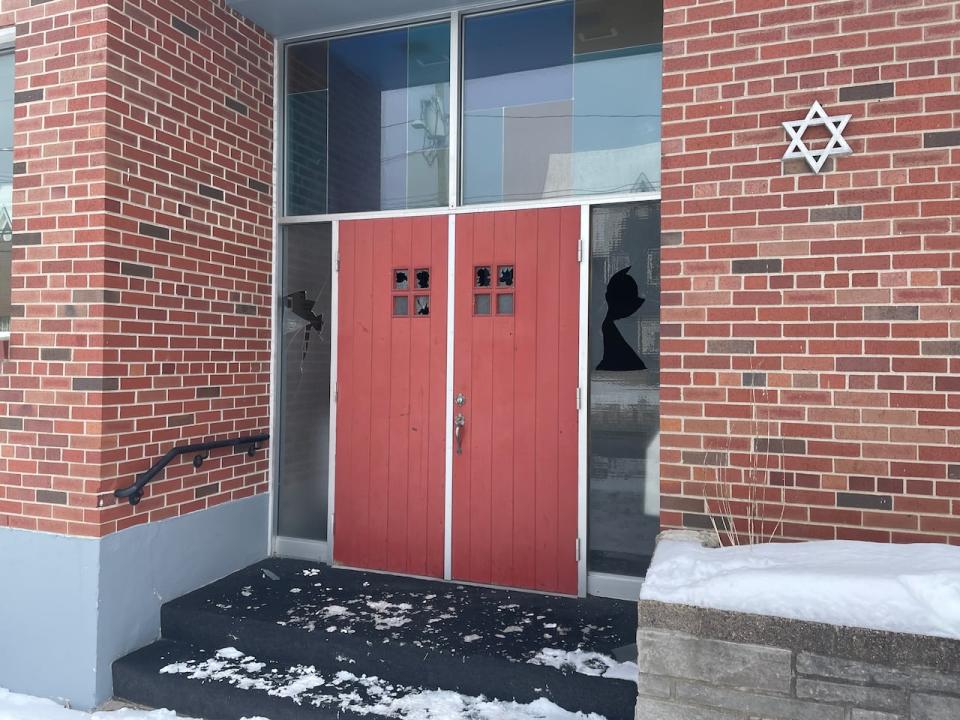 Broken glass covers the front steps of the Sgoolai Israel Synagogue in Fredericton.