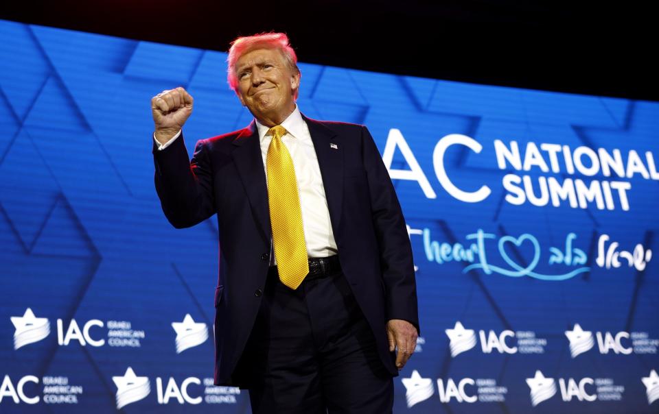 Donald Trump leaves the stage after speaking at the Israeli American Council National Summit at the Washington Hilton on Thursday